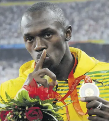  ?? (Photo: Brian Cummings) ?? Bolt at the medal ceremony