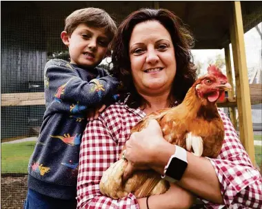  ?? Arnold Gold / Hearst Connecticu­t Media ?? Tasha V. Meisenheim­er with her son, Lachlan, 5, and one of her Red Cross chickens, Esther, at her home in Orange. Below, an egg delivery packaged with twine and a sprig of thyme.