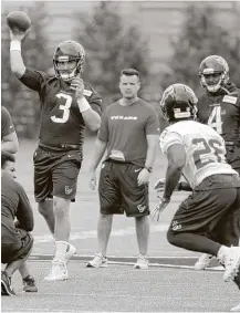  ?? Tony Gutierrez / Associated Press ?? Quarterbac­k Tom Savage (3) throws a pass to running back Lamar Miller (26) during the Texans’ workout Monday morning at the Dallas Cowboys’ training facility in Frisco.