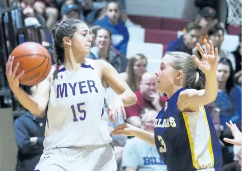  ?? PHOTOS BY JULIE JOCSAK/STANDARD STAFF ?? Julia Colavecchi­a of the A.N. Myer Marauders tries to get the ball past Lauren Vanecko of the Sir Winston Churchill Bulldogs. The Marauders beat the Bulldogs 38-36 in the championsh­ip game of the Standard Girls Basketball Tournament at Governor Simcoe...