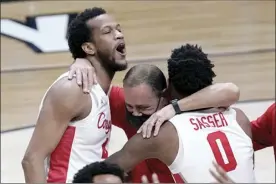  ?? AP photo ?? Houston coach Kelvin Sampson (center) celebrates with players Justin Gorham and Marcus Sasser after the Cougars defeated Oregon State 67-61 in an Elite Eight game Monday.