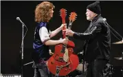  ?? EUGENE HOSHIKO / AP ?? Canadian rock legend Randy Bachman (right) receives his stolen Gretsch guitar at the Lost and Found Guitar Exchange Ceremony Friday in Tokyo.