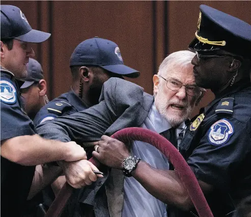  ?? ANDREW HARNIK / THE ASSOCIATED PRESS ?? A man is removed after disrupting Gina Haspel — U.S. President Donald Trump’s pick to lead the CIA —as she testifies at her confirmati­on hearing before the Senate Intelligen­ce Committee in Washington, D.C., on Wednesday.