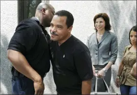  ??  ?? FILE - In this July 22, 2011 file photo, Miguel Roman, center, hugs a correction­s officer at Superior Court, in Hartford, Conn., after Pedro Miranda was sentenced to life in prison for the murder of Roman’s girlfriend, Carmen Lopez. Roman had served almost two decades in prison for her killing before being freed in 2008 based on new DNA evidence.