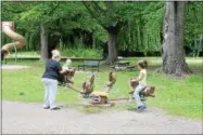  ??  ?? Cindy Massie of Troy playing with her kids at the Prospect Park playground.