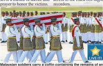  ?? EPA ?? Malaysian soldiers carry a coffin containing the remains of an MH17 victim at the Kula Lumpur Internatio­nal Airport in Sepang yesterday.