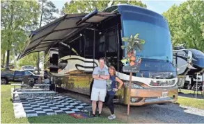  ?? JASEN VINLOVE/USA TODAY SPORTS ?? Jim and Diana Missig pose by their RV in the campground­s outside Talladega Superspeed­way in April.