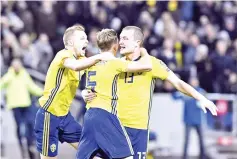  ??  ?? Sweden’s midfielder Jakob Johansson (R) celebrates scoring the opening goal with team mates Sweden’s midfielder Sweden’s midfielder Sebastian Larsson (C) and Sweden’s defender Martin Olsson during the FIFA World Cup 2018 qualificat­ion football match...