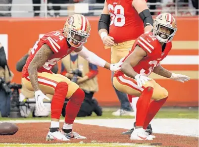  ?? HARRY HOW/GETTY ?? New Smyrna Beach High alum and San Francisco running back Raheem Mostert, right, celebrates a touchdown with teammate Kendrick Bourne in the first quarter against the Packers during Sunday’s NFC title game in Santa Clara, Calif. The 49ers won 37-20.