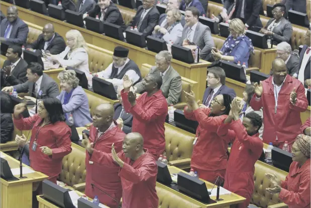  ??  ?? African National Congress members celebrate in the Cape Town parliament after South African president Jacob Zuma survived a no-confidence vote