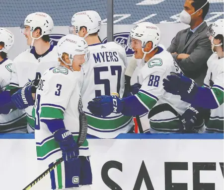  ?? PERRY NELSON/USA TODAY ?? Canucks defenceman Jack Rathbone celebrates his first NHL goal Thursday, against the Edmonton Oilers at Rogers Place.