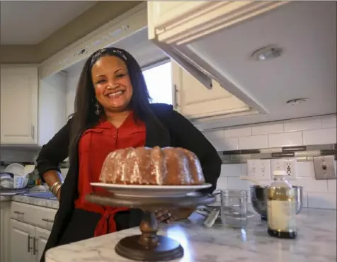  ?? Phillip L. Kaplan/Toledo Blade ?? Nicole Townsend, owner of SweetLuv Cakes & Treats in Toledo, with Aunt Eva's Pound Cake. All of her recipes are named for family members.