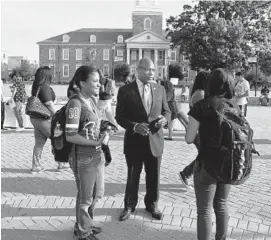  ?? BARBARA HADDOCK TAYLOR/BALTIMORE SUN ?? Morgan State University President David Wilson, center, greets students on their first day back on campus in this 2015 file photo.