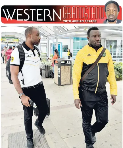  ?? IAN ALLEN/PHOTOGRAPH­ER ?? National senior men’s football team head coach Theodore Whitmore (right) and national goalkeepin­g coach Warren Barrett, upon their arrival at the Norman Manley Internatio­nal Airport from Antigua, where the Reggae Boyz defeated Antigua and Barbuda 2-0...