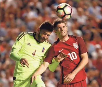  ??  ?? Christian Pulisic, right, fights for a header in Saturday’s USA-Venezuela friendly in Sandy, Utah. JEFF SWINGER, USA TODAY SPORTS