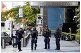  ?? RICHARD DREW / ASSOCIATED PRESS ?? New York City police officers arrive at CNN’s offices and its newsroom Wednesday. The site was evacuated because of a suspicious package.