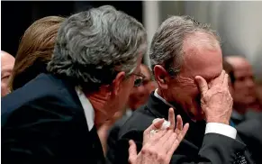  ?? AP ?? Former President George W. Bush, right, cries after speaking during the State Funeral for his father, former President George H.W. Bush, at the National Cathedral in Washington.