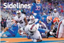  ?? OTTO KITSINGER/THE ASSOCIATED PRESS ?? Virginia running back Jordan Ellis scores a touchdown Friday against Boise State in Boise, Idaho. The Cavaliers beat the Broncos, 42-23.