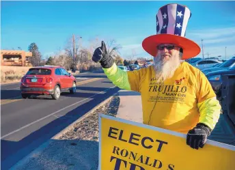  ?? EDDIE MOORE/JOURNAL ?? Robert Urban campaigns for mayoral candidate Ron Trujillo outside the St. John’s United Methodist Church polling place on Tuesday.