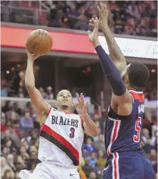  ?? Ap pHoto ?? COMIN’ AT YA: Blazers guard C.J. McCollum goes to the hoop vs. Wizards forward Markieff Morris last night.