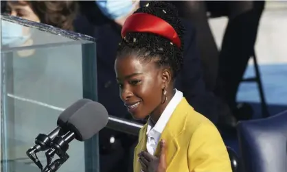  ?? Photograph: Erin Schaff/AP ?? Amanda Gorman wears a red Prada headband and yellow Prada jacket at Joe Biden’s inaugurati­on.