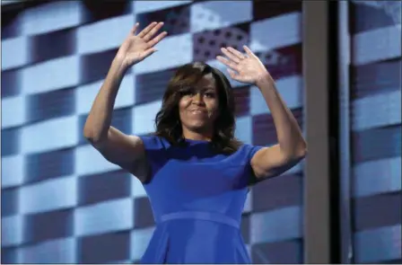  ?? CAROLYN KASTER — THE ASSOCIATED PRESS ?? First lady Michelle Obama waves after speaking to delegates during the first day of the Democratic National Convention in Philadelph­ia, Monday.