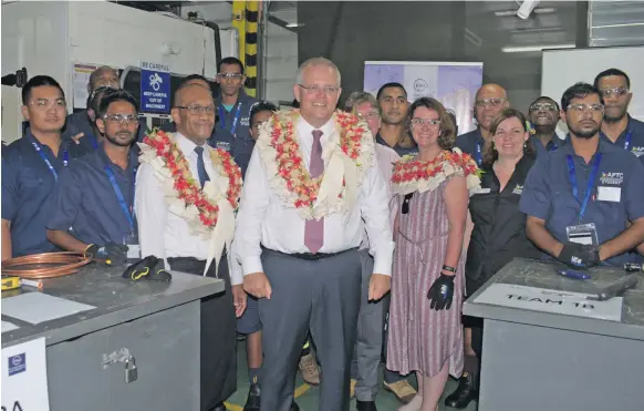  ??  ?? Minister for Infrastruc­ture, Transport, Disaster management Jone Usamate and Australian Prime Minister Scott Morrison with staff and students of APTC.