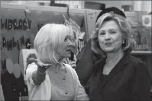  ??  ?? LIBRARY DEDICATED: Arkansas first lady Ginger Beebe, left, speaks with former Secretary of State Hillary Rodham Clinton at a children’s library and learning center Monday in Little Rock. The center is being named for the former first lady and secretary...