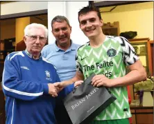  ??  ?? Don O’Donoghue (left) presenting the Golden Boot sponsored by Brian James to winner Matt Keane who scored 14 goals over the tournament, with Killarney Athletic FC Michael O’Shea at Woodlawn Killarney on Thursday.