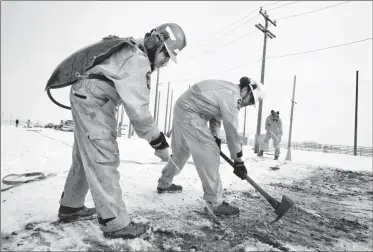  ?? Herald photo by Ian Martens ?? Dana White Quills sprays a jet of water from a pump while working alongside Ryan Day Chief and Tim Bastien as they participat­e in a wildland firefighti­ng training class Monday morning at the Lethbridge College animal husbandry facility east of the...