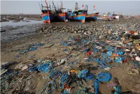  ?? Picture: Reuters ?? HUMAN WASTE. Fishermen boats are seen at a beach covered with plastic waste in Thanh Hoa province, Vietnam.