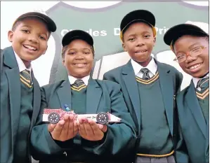  ?? Picture: CAMAGWINI MAVOVANA ?? GOING PLACES: Proud Charles Duna Primary School Grade 7 pupils, from left, Hlumelo Mkhuhlu, 11, his sister Lungisa Mkhuhlu, 12, Aviwe Mhlatyana, 12, and Silindokuh­le Zana, 12, are the Jaguar Primary School Challenge winners