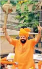  ?? DC ?? MLA Raja Singh raises a mace (gada) during the Shobha Yatra at Dhoolpet
—