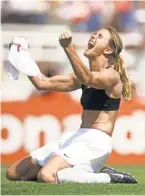  ?? ROBERTO SCHMIDT, AFP ?? In an iconic image, Brandi Chastain ripped off her jersey in celebratio­n after scoring the decisive penalty kick to give the U.S. women’s soccer team the 1999World Cup title.