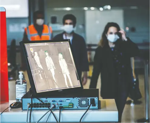  ?? CYRIL MARCILHAC Y / BLOOMBERG ?? A monitor displays a thermal camera image of travellers at Charles de Gaulle Airport, in Roissy, France, on May 14.
The coronaviru­s has opened doors to surveillan­ce and monitoring technology that many fear are here to stay.