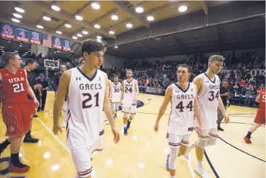  ?? D. Ross Cameron / Special to The Chronicle ?? St. Mary’s players (from left) Evan Fitzner, Jordan Ford, Calvin Hermanson, Cullen Neal and Jock Landale walk off the court after their 67-58 overtime loss to Utah in an NIT semifinal game at McKeon Pavilion.