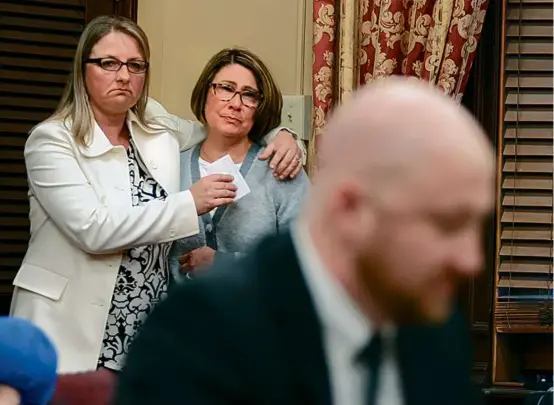  ?? MATTHEW J. LEE/GLOBE STAFF ?? Michael Cesaro’s mother, Susan (center, supported by Meghan Reilly), watched while he testified in front of a Rhode Island Senate committee in support of a bill dropping the statute of limitation­s for child sex abuse lawsuits.