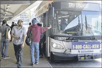  ?? DAVID BARNES /AJC ?? Passengers exit a a bus at the Doraville MARTA Station on Friday. The transit agency reported ridership up about 25 percent as many commuters anticipate­d traffic being more congested than usual because of the I-85 bridge collapse.