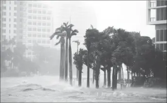  ??  ?? Water rises up to a sidewalk by the Miami River as Hurricane Irma arrives at south Florida, in downtown Miami, Florida. REUTERS/Carlos Barria