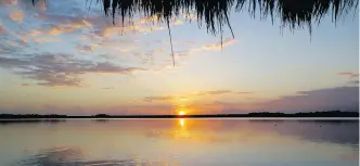  ?? TRACY BARNETT/FOR THE WASHINGTON POST ?? The daily spectacle of sunrise over Bacalar Lagoon is a stunning array of colour. Northern developers and the tourist boom are threatenin­g the stability of the region.