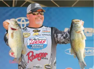  ?? B.A.S.S. PHOTO/SEIGO SAITO ?? Spring City resident John Murray shows off his two big bass from Saturday’s collection that helped propel him to the Bassmaster Elite tournament victory Sunday in Louisiana. He earned $100,000 for his four-day haul of 77 pounds, 10 ounces.