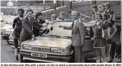  ??  ?? In the driving seat: Ellis with a giant car key to mark a sponsorshi­p deal with Austin Rover in 1983