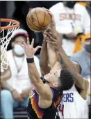  ?? AP photo ?? The Suns’ Devin Booker beats the Clippers’ Rajon Rondo to a rebound during the second half of Phoenix’s 120-114 victory over Los Angeles on Sunday.