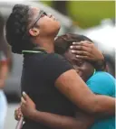  ?? STAFF FILE PHOTO BY ANGELA LEWIS FOSTER ?? Treasure Strickland, left, and Keaira Colbert comfort each other during a vigil in memory of Ashley McKenzie on June 14.