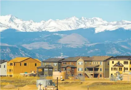  ??  ?? Workers build homes in the Anthem subdivisio­n on March 15 in Broomfield near the spot of the proposed Sheridan pad, which could have up to 40 wells. A rebound in oil prices is spurring a rebound in drilling. RJ Sangosti, The Denver Post