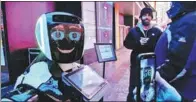  ?? REUTERS ?? Above: Passers-by interact with a robot in New York informing the public about the novel coronaviru­s pneumonia outbreak.