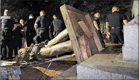  ?? AP/GERRY BROOME ?? Police stand guard Aug. 20 around the Silent Sam Confederat­e statue that protesters toppled on the campus of the University of North Carolina in Chapel Hill.