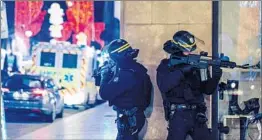  ?? ABDESSLAM MIRDASS/GETTY-AFP ?? Police officers stand guard near the scene of a shooting Tuesday in Strasbourg, France.