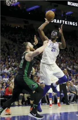  ?? MATT SLOCUM — THE ASSOCIATED PRESS ?? Sixers center Joel Embiid goes up for a shot against the Boston Celtics’ Aron Baynes during the first half of Game 3 Saturday night the Wells Fargo Center. at