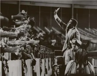  ?? Staff file photo ?? Charley Pride waves to the crowd at the Houston Livestock Show and Rodeo in March 1970. The singer tried to break into Major League Baseball before breaking country music’s color barrier.